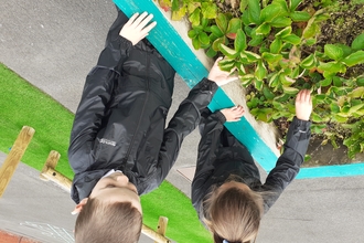 Two children planting flowers