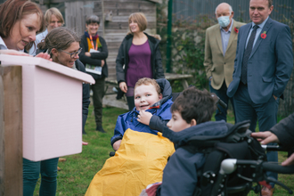 Two pupils in wheelchairs undertaking a sensory activity outdoors