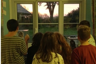 Six children looking out a window