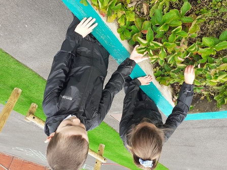 Two children planting flowers