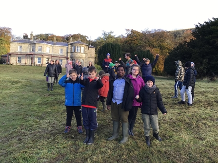 Pupils standing in front of residential building